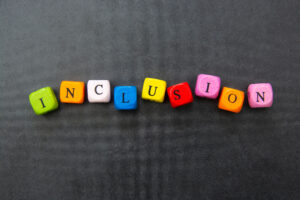 inclusion spelled out in different colored blocks on gray background